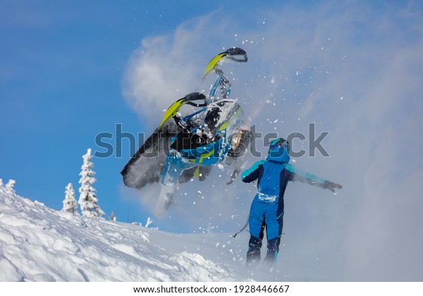 epic snowmobile fall.\
sports snowmobiles in the mountains. bright skidoo motorbike and\
suit without brands. Winter fun, snowmobilers sports riding. high\
resolution photos