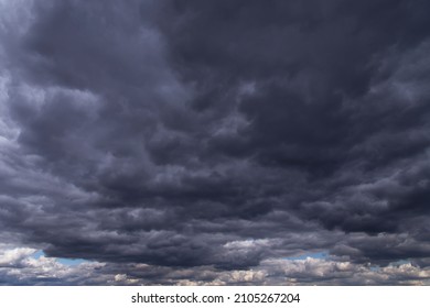 Epic storm sky with many dark grey cumulus rainy clouds background texture, thunderstorm, wind weather