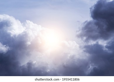 Epic storm sky with sun and sunlight. White and dark blue violet cumulus clouds background texture, thunderstorm - Shutterstock ID 1955411806
