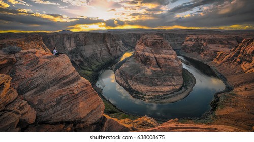 Epic sunset image of young woman hiker overlooking the Colorado River at Horseshoe Bend. Located in Page, Arizona. - Shutterstock ID 638008675