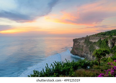 Epic Sunset Twilight of Uluwatu Temple cliff with pavilion and blue sea in Bali, Indonesia

