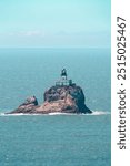 Epic Tillamook Lighthouse , Cannon Beach, Oregon in the shiny ocean water , Ecola State Park , close up stunning view of lighthouse surrounded waves