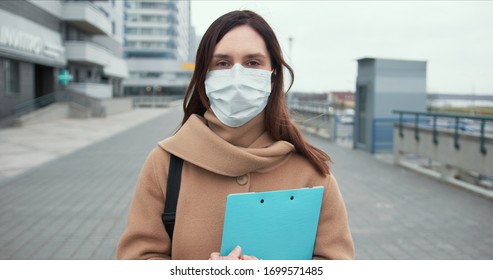 Epidemic Control Worker. Portrait Of Caucasian Social Care Woman In Medical Face Mask In Empty Street During Quarantine.