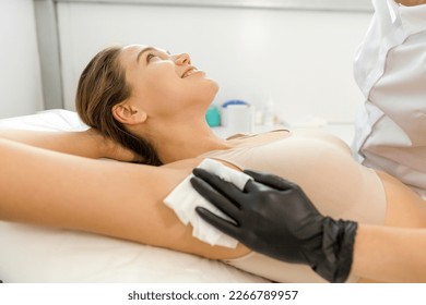 Epilation of the armpit in a beauty salon to a beautiful girl removing hair close-up - Shutterstock ID 2266789957