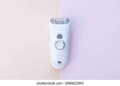 Epilator for women. Hair removal tool, machine. Shaving personal hygiene female accessories. Bathroom household devices. Modern epilator on pink background. - Shutterstock ID 2040621893