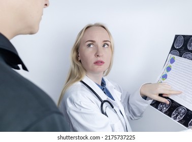 Epileptologist examines patient MRI and electroencephalogram. Concept treating epilepsy and helping people who suffer from this disease. Neurologist at work. Pathology of the brain. Seizure activity - Shutterstock ID 2175737225