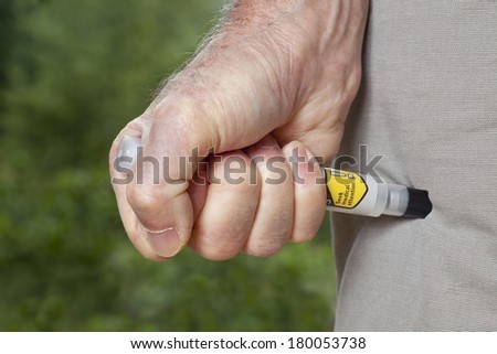 Epinephrine is injected in the upper thigh using an auto-injector syringe as an emergency treatment for an acute allergic reaction to food or insect stings.