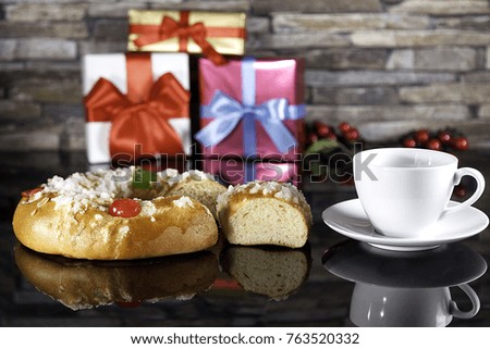 epiphany cake and cup of coffe with  Christmaspresents and mistletoe