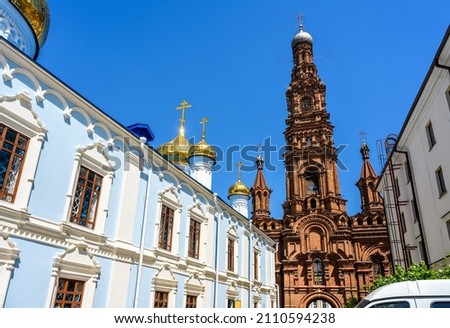 Epiphany Cathedral with ornate bell tower, Kazan, Tatarstan, Russia. This old tall belfry is landmark of Kazan. Panorama of historical buildings on Bauman street in Kazan city center in summer.