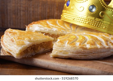 Epiphany Twelfth Night Cake, Almond Galette des Rois, Cake of the Kings, on dark wood rustic background. 