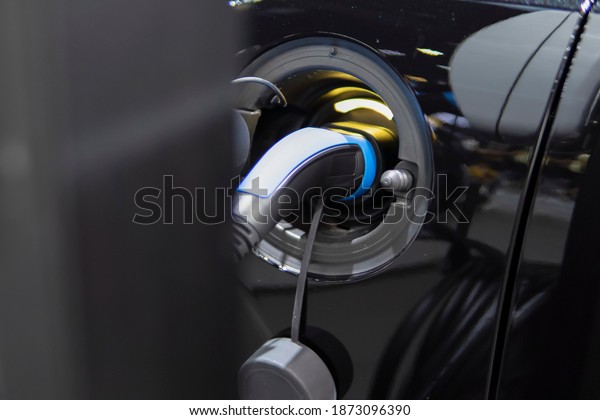 E-power car concept, car electric power\
charging, EV car concept, technology power of the car, close up EV\
charging.