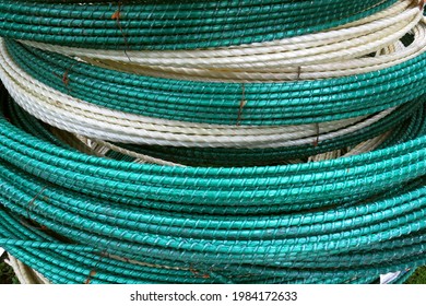 Epoxy fiberglass reinforcement for concrete reinforcement. The color is green, white. Bundle close-up. Reinforcing frame. Fiberglass reinforcement. Composite rebar in a roll