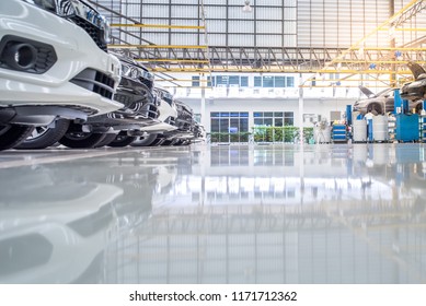 Epoxy Floor Mix The Resin In The Auto Repair Service Garage. New Epoxy Floor For Industrial Car Repair Floors