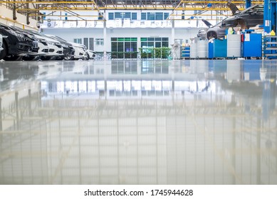 Epoxy Floor Mix The Resin In The Auto Repair Service Garage. New Epoxy Floor For Industrial Car Repair Floors