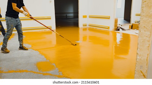 epoxy flooring applicator performs painting works with polyurethane epoxy mortar