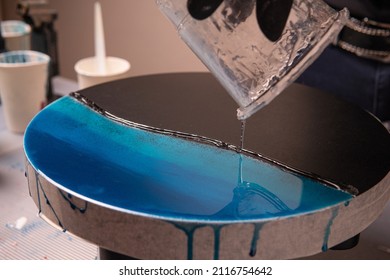 Epoxy resin. The creative hobby process of creating an artist's painting of a liquid resin imitation of the sea on a slate stone board - Powered by Shutterstock