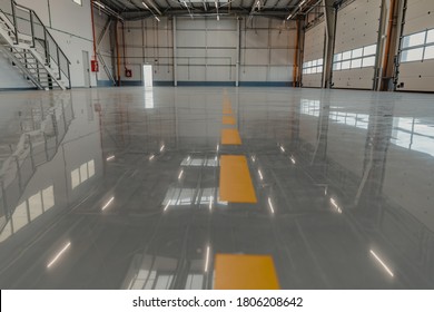 Epoxy and waxed flooring with colorful signage in car service