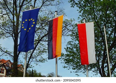 EPPSTEIN, GERMANY - May 09, 2021: The Flags Of Europe, Germany And Hesse Fly In Front Of Eppstein Railway Station, Germany  For A Hessian, Patriotism Means Being A Citizen Of The World