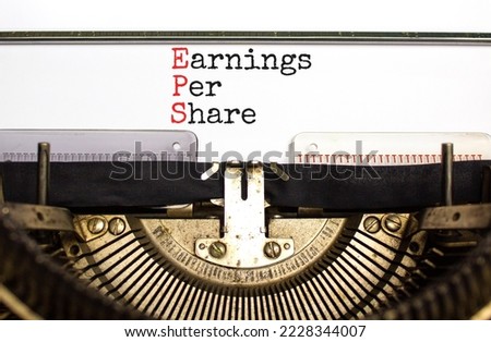 EPS earnings per share symbol. Concept words EPS earnings per share typed on old retro typewriter. Beautiful white background. Business and EPS earnings per share concept. Copy space.