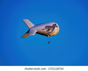 EPSOM DERBY: Helium Airship With Running Zebra, Hovering Above Epsom Downs Racecourse During The Famous Annual Horse Racing Event. In 2020 It's Been Postponed Due To Coronavirus Pandemic. JUNE 5, 2015