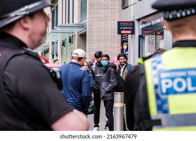 Epsom Surrey, London UK, June 04 2022, Group Of Peaceful Asian Youths And Two Police Officers