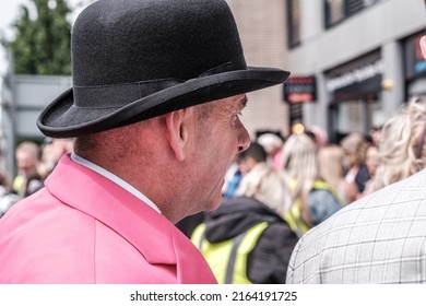 Epsom Surrey, London UK, June 04 2022, Senior Man Wearing Traditional Bowler Hat And Bright Pink Jacket