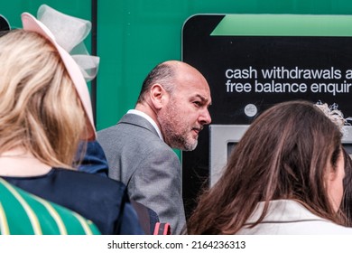 Epsom Surrey, London UK, June 04 2022, Line Of Men And Women Queuing To Withdraw Money From An ATM Cash Point Machine