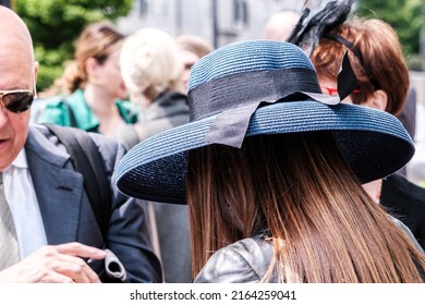 Epsom Surrey, London UK, June 04 2022, Young Woman Wearing Blue Rim Hat With Long Brown Hair Rear Shot