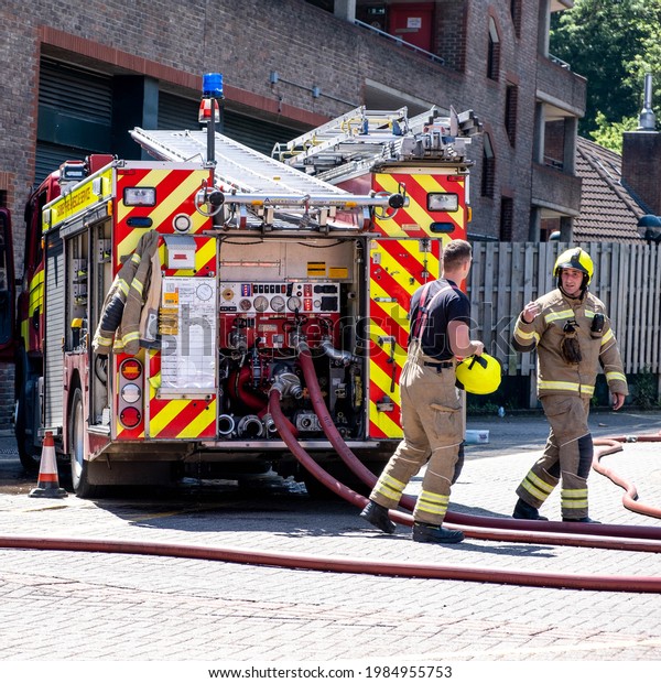 Epsom Surrey London\
UK, June 03 2021, Fire Truck And Fire Fighters Attending A Fire In\
A Public Car Park