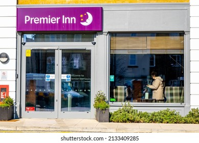 Epsom Surrey London UK, March 8 2022, Entrance Of Modern Premier Inn Hotel With Customer Standing In The Window