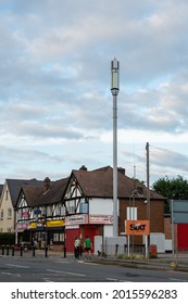 EPSOM, SURREY, UK - 2021 July 27: A newly installed high 5G network phone mast at a street corner in a residential area