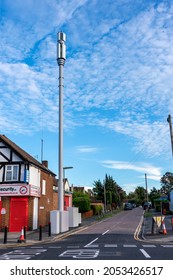 EPSOM, SURREY, UK - 2021 OCT 6: A 5G Mobile Network Mast At A Street Corner Innresidential Area At Dust With Blue Sky And Scattered Clouds