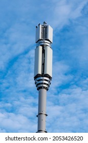 EPSOM, SURREY, UK - 2021 OCT 6: Close-up Of A 5G Mobile Network Mast Against A Blue Sky And Scattered Clouds