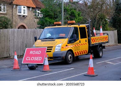 EPSOM, SURREY, UK - CIRCA 2019 JANUARY: Road Closed Sign And A Driver Sitting In An Orange Truck From Highway Maintenance Traffic Management Waiting