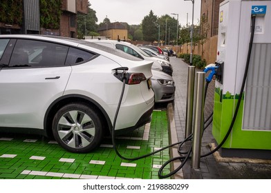 EPSOM, UK - CIRCA SEPTEMBER 2022: An Electric Car Or EV Is Being Charged By A Rapid Charger At A Supermarket