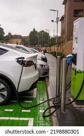 EPSOM, UK - CIRCA SEPTEMBER 2022: An Electric Car Or EV Is Being Charged By A Rapid Charger At A Supermarket