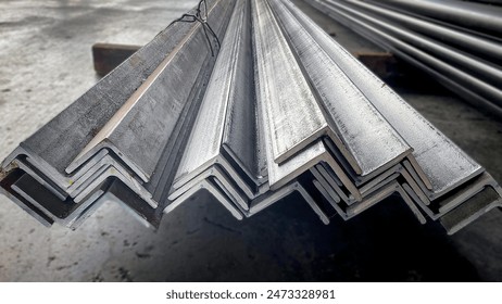 Equal Angles Steel angle iron Metal profile angle in packs at the warehouse of metal products.The arrangement of hot-dip green steel angles on the rack in warehouseMetal profile angle in packs