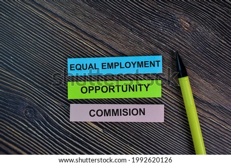 Equal Employment Opportunity Commision write on sticky notes isolated on Wooden Table. Selective focus on equal opportunity commision text