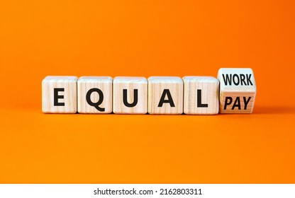 Equal pay and work symbol. Turned the wooden cube and changed words equal pay to equal work. Beautiful orange background. Copy space. Business and equal pay and work concept.