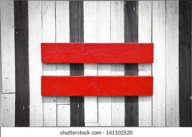 Equal Sign Symbol On The Dark Wooden Wall