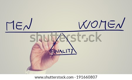 Equality between men and women, a conceptual image of the status of female rights with a man drawing a seesaw on a virtual interface balancing the two concepts on opposite ends in equilibrium. 