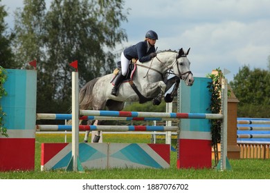 Equestrian Girl Jumping Sportive Horse