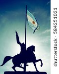 The Equestrian monument to General Manuel Belgrano, a landmark of Buenos Aires, and the Argentinian Flag in Buenos Aires, Argentina. It is located at Plaza de Mayo, in front of the Casa Rosada