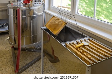 Equipment for beekeeping, demonstrating a hood and frames for honeycombs, ready for processing, a honey machine. - Powered by Shutterstock