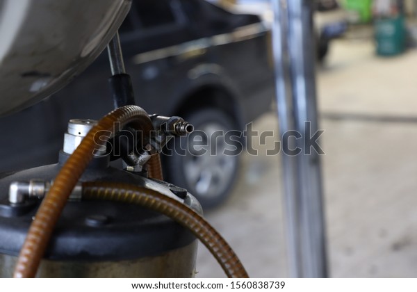 equipment in a car workshop, car maintenance,\
engine oil change