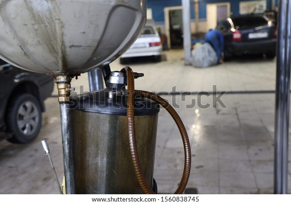 equipment in a car workshop, car maintenance,\
engine oil change