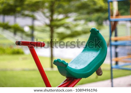 Equipment in a children's play park grass.Downed horse in playground