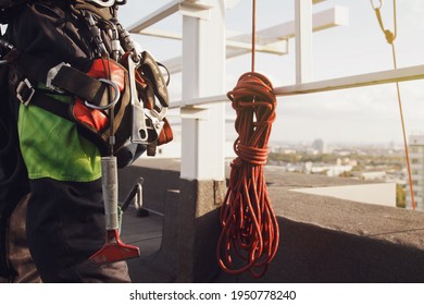 Equipment Of Industrial Mountaineering Worker On Roof Of Building During Industrial High-rise Work. Climbing Equipments Before Starting Job. Rope Laborer Access. Concept Of Urban Works. Copy Space