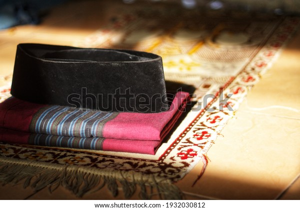equipment for Islamic religious worship. prayer mat,\
sarong, and cap