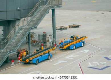 Equipment of a machine for loading and unloading luggage on an airplane. Serviced in preparation for boarding.